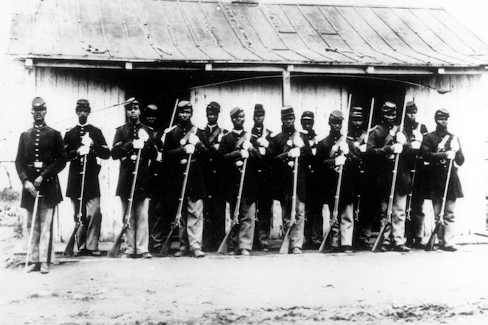 ADVANCE FOR USE SATURDAY, FEB. 6, AND THEREAFTER - FILE - This is an undated 1860's file photo of a military police detachment, known as provost guards, of the 107th U.S. Colored Infantry lined up at Fort Corcoran near Washington, D.C. It's been 150 years since black soldiers from U.S. Colored Infantry units began returning home from their service in the South, where more than 175,000 members fought - and in some cases, died - to free fellow African-Americans from slavery. (AP Photo/Library of Congress, File)