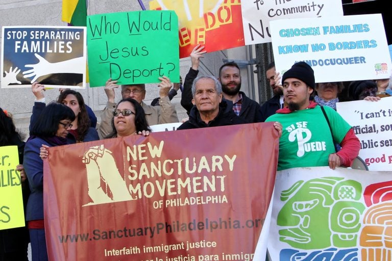 Members of the New Sanctuary Movement protest outside City Hall