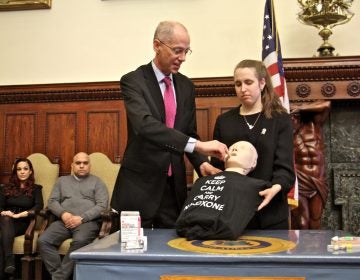 Philadelphia Health Commissioner Thomas Farley demonstrates the use of naloxone spray during a press conference at City Hall.