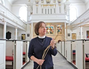 Parishioners at St. Peter's Episcopal Church in Philadelphia will wave locally grown ornamental grasses rather than palm fronds during Palm Sunday services. Rector Claire Nevin-Field holds a sprig of Miscanthus sinensis, an ecologically friendly alternative to the traditional palm.