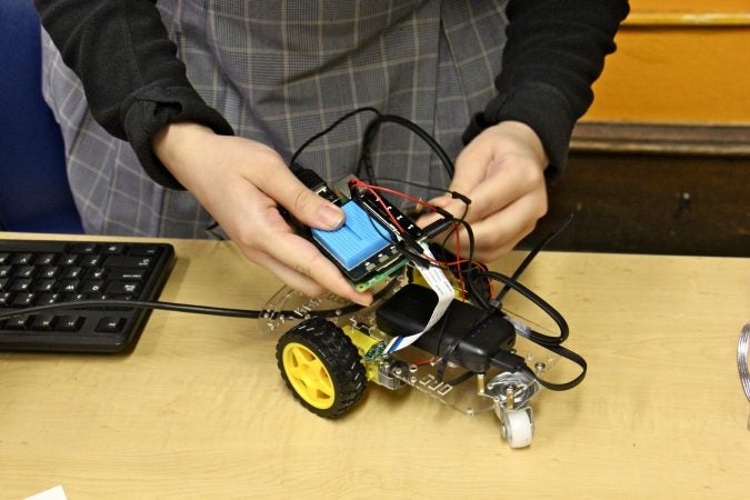 Student teams assemble and program vehicles as part of their autonomous systems engineering class. (Emma Lee/WHYY)