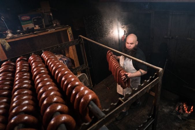 Frank Musser helps cook kielbasa at Czerw's Polish Kielbasa in Port Richmond. (Branden Eastwood for WHYY)