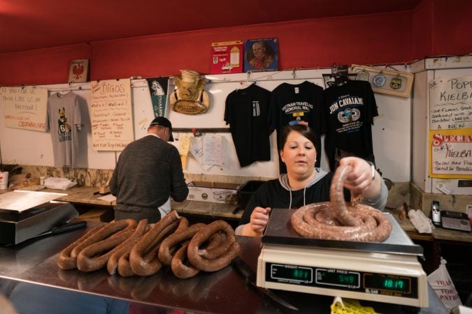 Nicole Crouse weighs out kielbasa on Good Friday at Czerw's Polish Kielbasa in Port Richmond. (Branden Eastwood for WHYY)