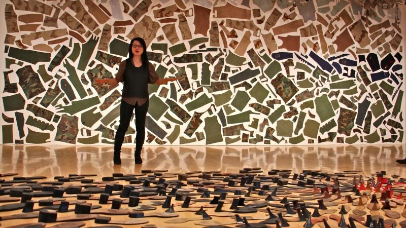 Jean Shin uses discarded objects to create monumental artworks. She stands between 