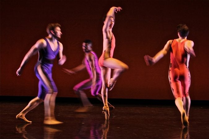 Dancers dance onstage.