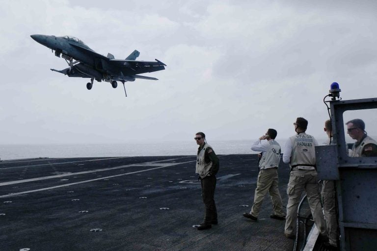 A Navy fighter jet comes in for a landing on the aircraft carrier USS Carl Vinson in the South China Sea. (Anthony Kuhn/NPR)