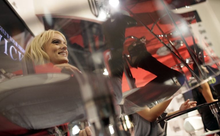 Adult film star Stormy Daniels, left, signs autographs at the AVN Adult Entertainment Expo in Las Vegas, Sunday, Jan. 11, 2009.