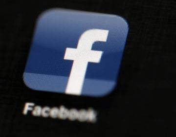 In this May 16, 2012, file photo, the Facebook logo is displayed on an iPad in Philadelphia. Facebook suspended Cambridge Analytica, a data-analysis firm that worked for President Donald Trump's 2016 campaign, over allegations that it held onto improperly obtained user data after telling Facebook it had deleted the information. (Matt Rourke/AP Photo, File)