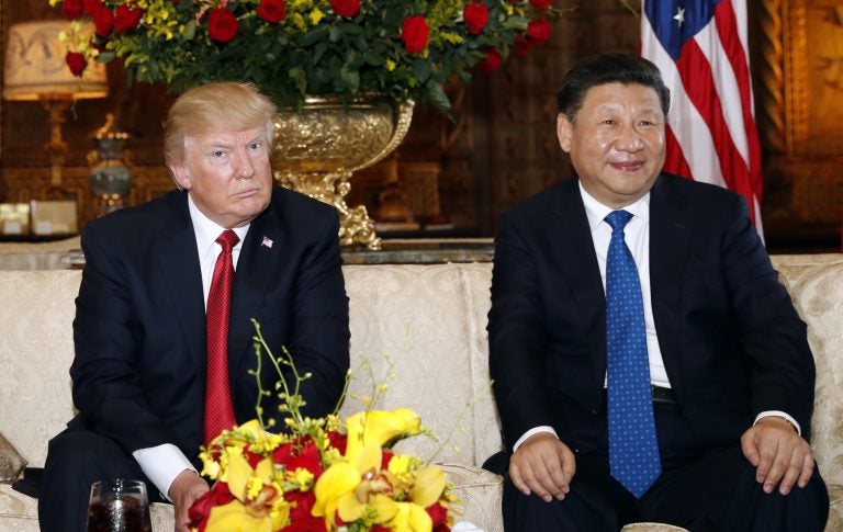 President Donald Trump and Chinese President Xi Jinping, sit as they pose for photographers before a meeting at Mar-a-Lago, Thursday, April 6, 2017, in Palm Beach, Fla.