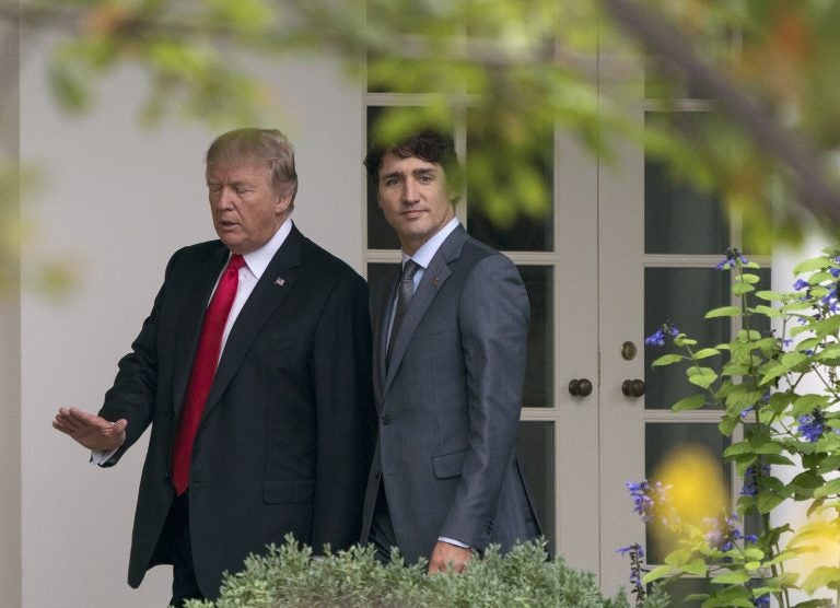 President Donald Trump and Canadian Prime Minister Justin Trudeau walk along the Colonnade to the Oval Office of the White House in Washington, Wednesday, Oct. 11, 2017.