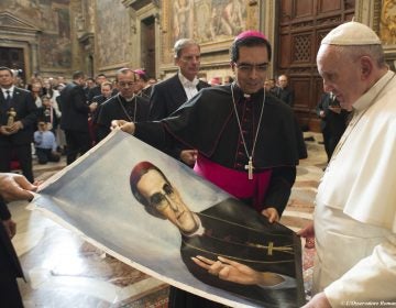 In 2015, Pope Francis is presented with an image of Roman Catholic Archbishop Oscar Romero during a private audience granted to participants to the pilgrimage from El Salvador at the Vatican. Pope Francis has cleared the way for slain Salvadoran Archbishop Oscar Romero to be made a saint, declaring that a churchman who stood up for the poorest of the poor in the face of right-wing oppression should be a model for Catholics today. (L'Osservatore Romano/Pool Photo via AP)