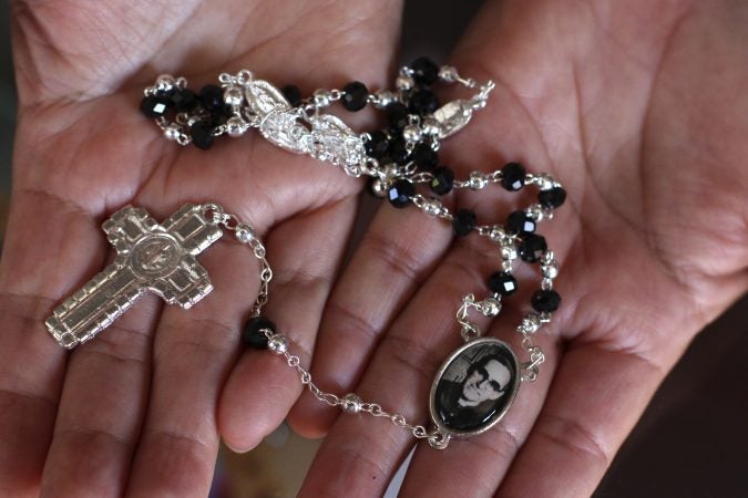 A woman holds a rosary with the image of the slain Salvadoran Archbishop Oscar Romero inside the religious library of the Divine Providence chapel, in San Salvador, El Salvador, Wednesday, March 7, 2018. Pope Francis has cleared the way for sainthood for Romero who was shot and killed while celebrating Mass in the chapel in 1980. (Salvador Melendez/AP Photo)