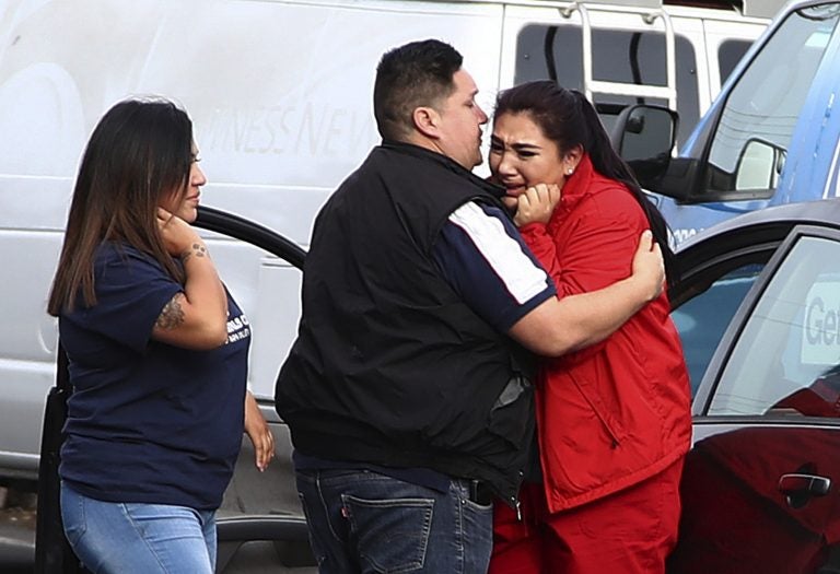 Fernando Juarez, 36, of Napa, (center), embraces his 22-year-old sister Vanessa Flores, (right), at the Veterans Home of California on Friday March 9, 2018. in Yountville, Calif. Flores, who is a caregiver at the facility, exchanged texts with family while sheltering in place. A gunman took at least three people hostage at the largest veterans home in the United States on Friday, leading to a lockdown of the sprawling grounds in California, authorities said. (Ben Margot/AP Photo)
