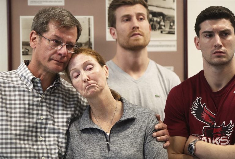 Parents John and Lisa Dombroski, left, stand with their sons John, behind, and Kevin during a press conference regarding their missing son and brother Mark, at the Hamilton Police Station in Hamilton, Bermuda, Monday, March 19, 2018. Mark Dombroski, 19, a member of the rugby team at Saint Joseph's University in Philadelphia, disappeared early Sunday after a night of socializing at the end of an international rugby tournament. (Blaire Simmons/The Royal Gazette via AP)