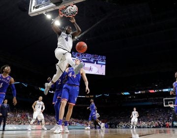 Villanova's Eric Paschall (4) dunks over Kansas's Mitch Lightfoot (44) during the second half in the semifinals of the Final Four NCAA college basketball tournament, Saturday, March 31, 2018, in San Antonio. (AP Photo/David J. Phillip)