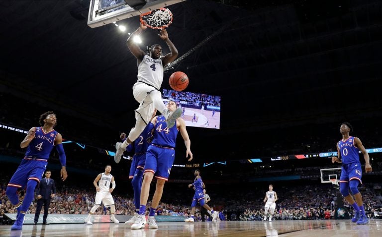 Villanova's Eric Paschall (4) dunks over Kansas's Mitch Lightfoot (44) during the second half in the semifinals of the Final Four NCAA college basketball tournament, Saturday, March 31, 2018, in San Antonio. (AP Photo/David J. Phillip)