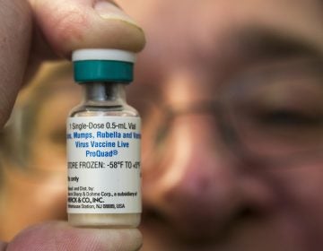 A pediatrician holds up a measles