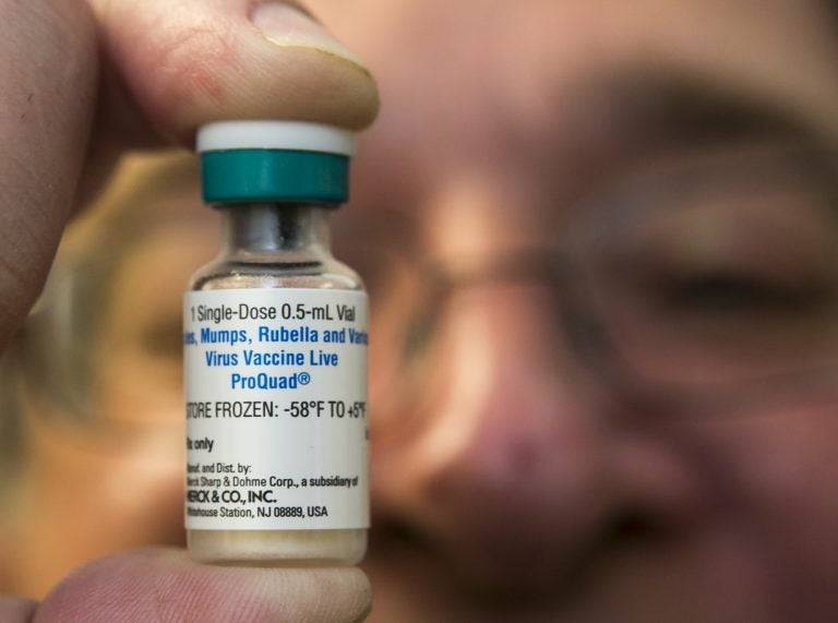 A pediatrician holds up a measles