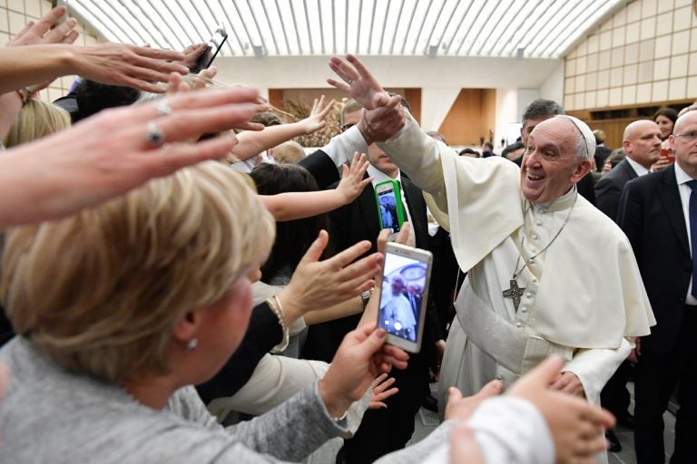 Pope Francis is cheered by faithful during an audience with health workers, in the Paul VI hall at the Vatican, Saturday, March 3, 2018. (L'Osservatore Romano/ANSA via AP)