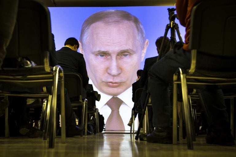 Journalists watch as Russian President Vladimir Putin gives his annual state of the nation address in Manezh in Moscow, Russia, Thursday, March 1, 2018. (Alexander Zemlianichenko/AP Photo)