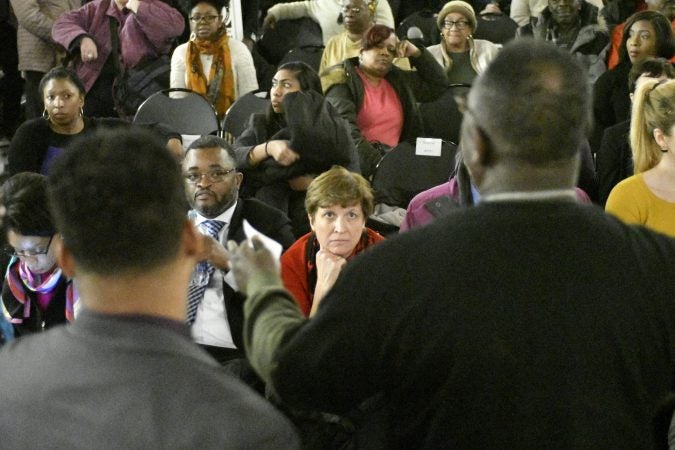 Community members, activist and students shut down a town hall meeting about the proposed $130 million, 35,000 seat  stadium on Temple's campus, on Tuesday. (Bastiaan Slabbers/for WHYY)