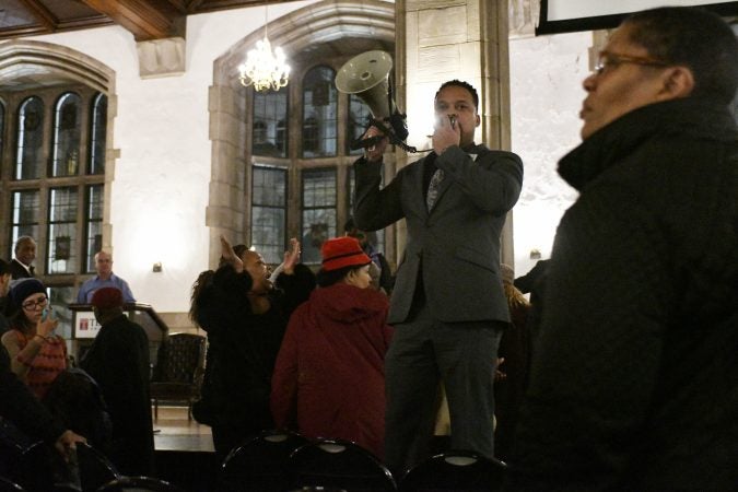 Activist take over the stage after Temple University's President Richard M. Englert cuts short a presentation outlaying plans for the proposed $130 million, 35,000 seat stadium on Temple's campus, during a town hall meeting on Tuesday. (Bastiaan Slabbers/for WHYY)