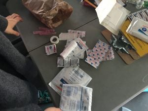 Sheila Dhand looks over her nurse supplies to treat wounds.