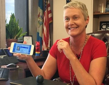 DelDOT Secretary Jennifer Cohan shows her digital driver's license on her cellphone. (Mark Eichmann/WHYY)