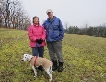 Marianne and Rick Atkinson with their dog Spot, on their property in Clearfield County. (Susan Phillips/StateImpact Pennsylvania)