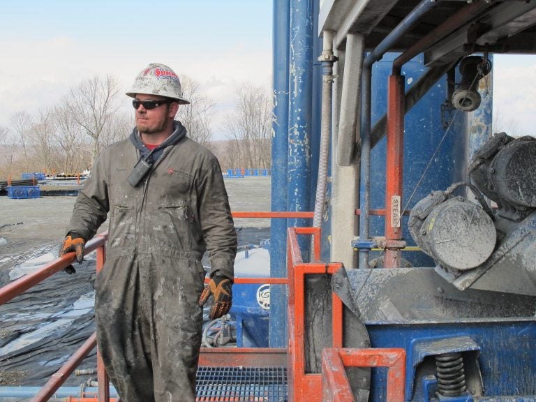 A natural gas worker on a rig in Susquehanna County in 2012. A StateImpact/Franklin & Marshall poll out Thursday shows a majority of registered voters, 69 percent, favor policies that would promote renewable wind and solar power over fossil fuel sources like coal and natural gas. (Susan Phillips/StateImpact Pennsylvania)