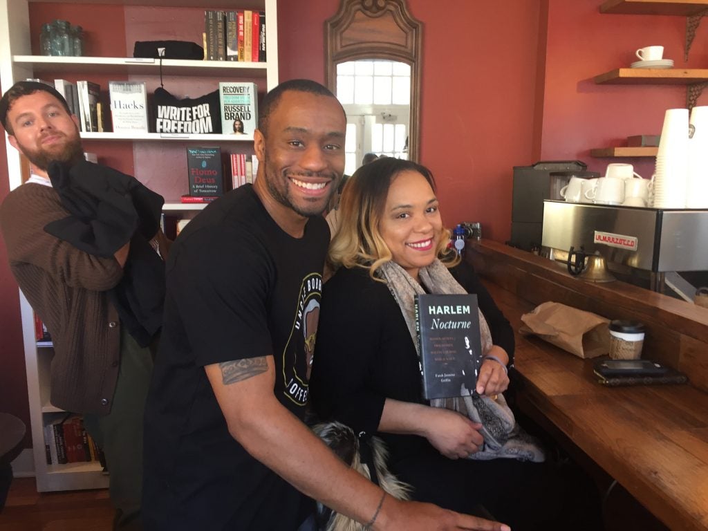 Marc Lamont Hill inside his coffeeshop with a patron.