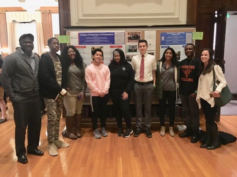 This year’s College of Physicians Teva interns presenting a poster on gun violence. (Courtesy of Jacqui Bowman)