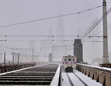 A regional rail train departs 30th Street Station as the snow intensifies.