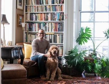 James Earl Davis, a Professor of Urban Education at Temple University and his golden Doodle, Baldwin, pictured in his home in East Germantown.