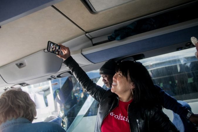 Philadelphia City Councilwoman Helen Gym takes a selfie with students, parents and teachers from Science Leadership Academy Beeber Campus on a bus bound for Washington D.C to attend the March for Our Lives. (Brad Larrison for WHYY)