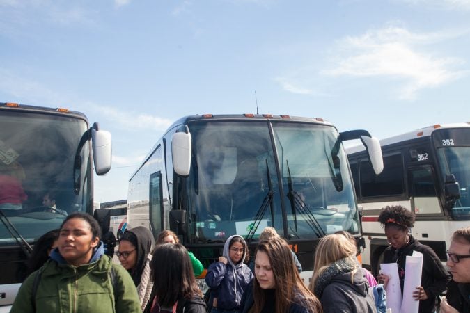Students, parents and teachers from Science Leadership Academy Beeber Campus exit a bus after arriving in Washington D.C Saturday morning for the March for Our Lives. (Brad Larrison for WHYY)