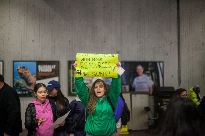 Science Leadership Academy Junior Lourdes Blazquez holds up her sign in a Metro Station as she and her classmates made their way toward the March for Our Lives in Washington D.C. (Brad Larrison for WHYY)