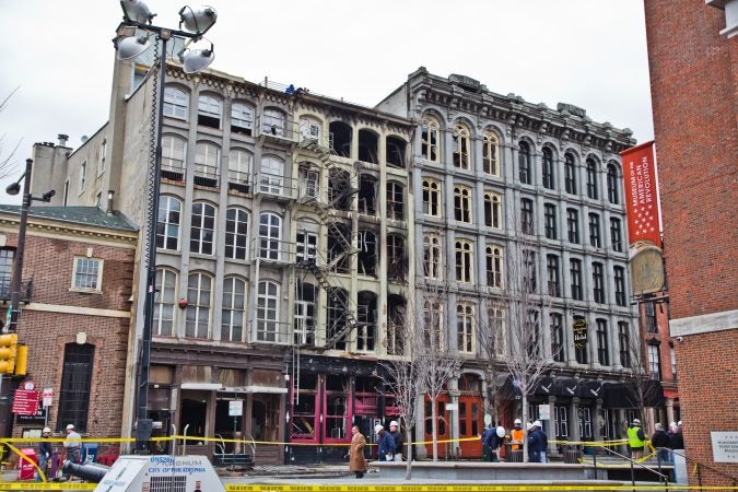 The area around the 4-alarm fire at 239 Chestnut Street which was contained around 7:30 a.m. this morning is closed off and being evaluated for further risk. (Kimberly Paynter/WHYY)