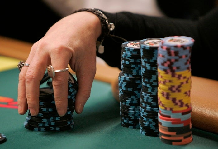 Professional poker player Annie Duke shuffles her chips during the US$50,000 buy-in HORSE event of World Series of Poker at the Rio hotel-casino in Las Vegas, Monday, June 25, 2007.  (AP Photo/Jae C. Hong)