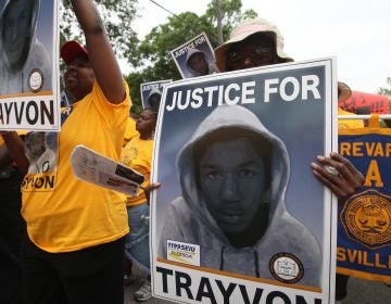 Protesters hold up signs in a march and rally for slain Florida teenager Trayvon Martin in Sanford, Fla., on March 31, 2012. (Julie Fletcher/AP)