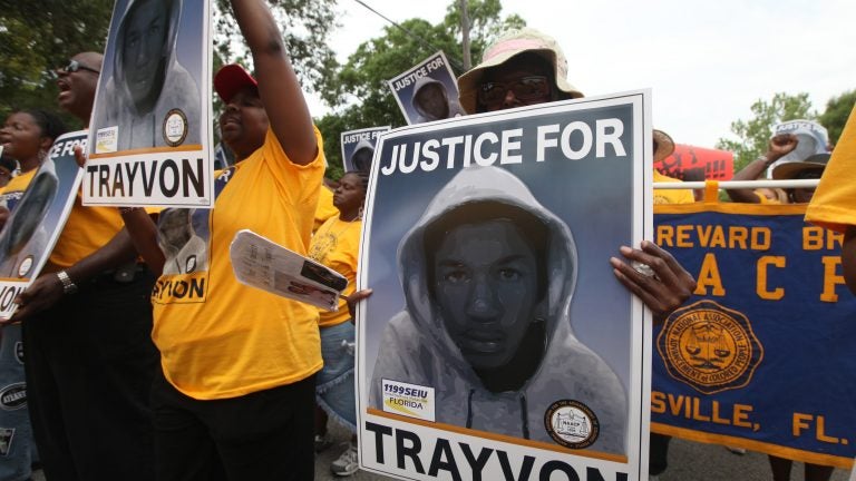 Protesters hold up signs in a march and rally for slain Florida teenager Trayvon Martin in Sanford, Fla., on March 31, 2012. (Julie Fletcher/AP)