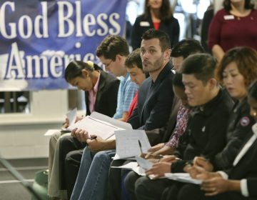 Newly naturalized U.S citizens complete voter registration forms in Bethel Park, Pa., in November 2017. The 2020 census will ask respondents whether they are citizens.