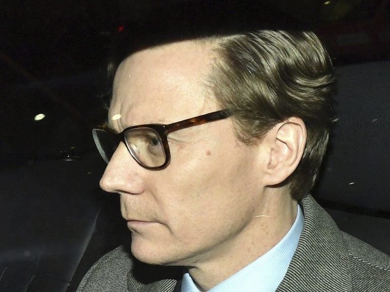 Chief Executive of Cambridge Analytica (CA) Alexander Nix, leaves the firm's offices in central London on Tuesday. He was suspended amid a controversy about the company's use of social media data.
