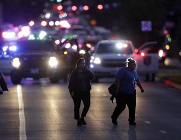 People evacuate as emergency vehicles stage near the site of another explosion on Tuesday in Austin, Texas.