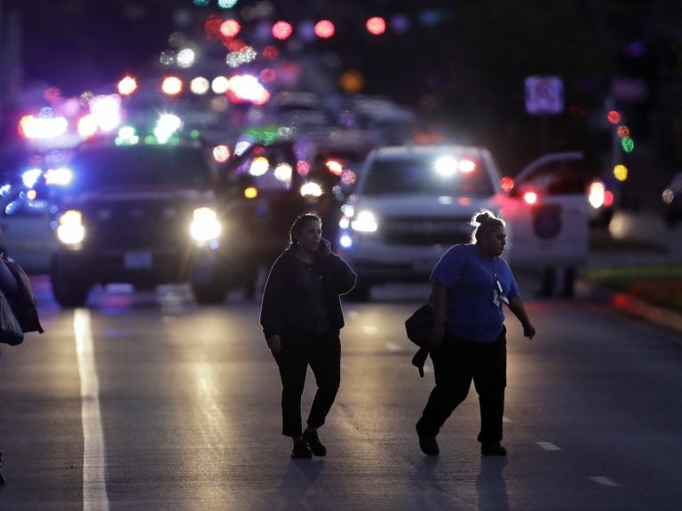 People evacuate as emergency vehicles stage near the site of another explosion on Tuesday in Austin, Texas.