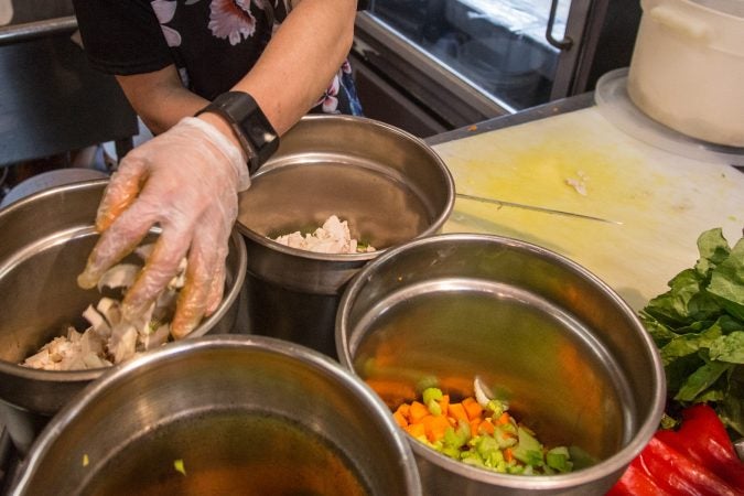 The soups are made each morning, chicken noodle is a deli staple. Like everything else, the soups are also doubled in preparation for the anticipated influx of customers coming from the first day of the Philadelphia Flower Show. (Emily Cohen for WHYY)