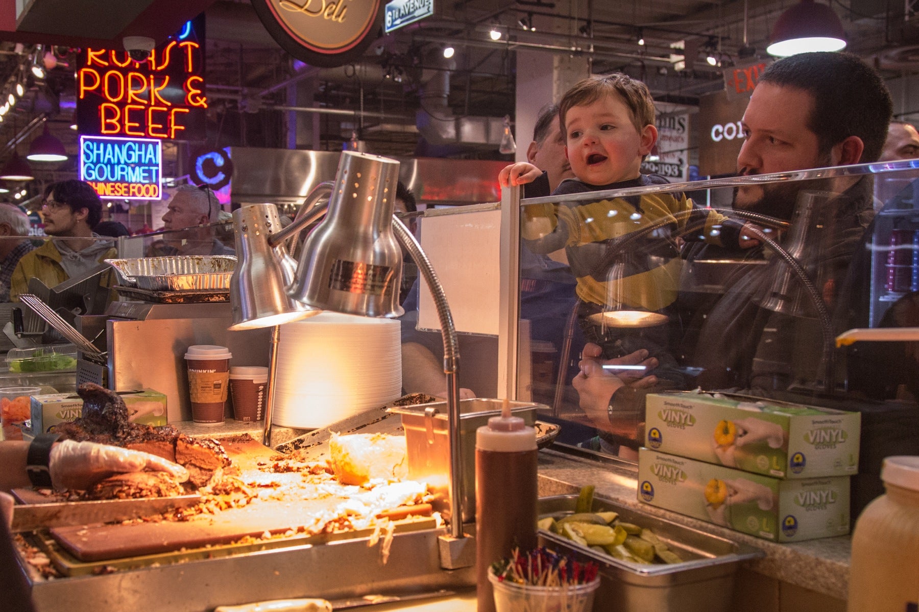 A young Hershel's patron watches the food preparation. 