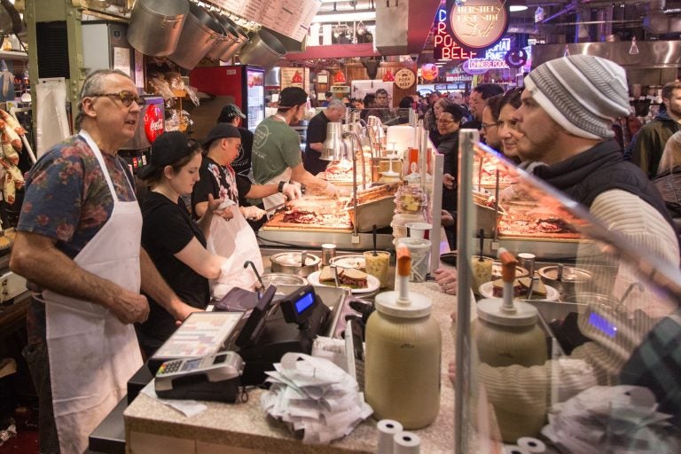 Hershel's East Side Deli chef and co-owner Andy Wash (left) and his crew tend to customers. With a seemingly endless line, it is all hands on deck with each worker prepping different orders.