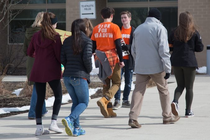 Student organizers walk back into school after a successful walkout and rally