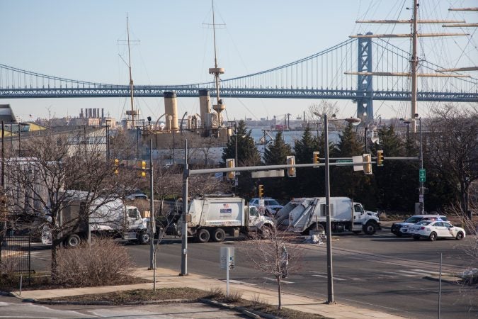 Trash trucks and police vehicles block off the entrance and route of the Philadelphia March for Our Lives, March 24, 2018. (Emily Cohen for WHYY)